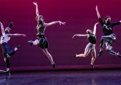 Image of dancers jumping on stage
